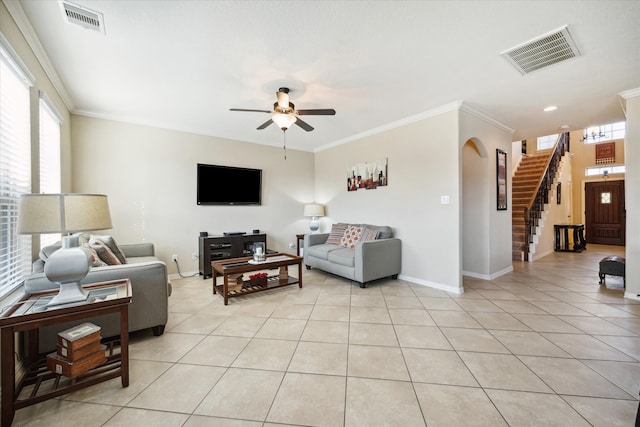 tiled living room featuring ceiling fan and ornamental molding