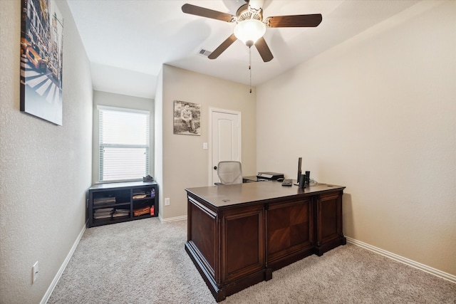 carpeted office space featuring ceiling fan