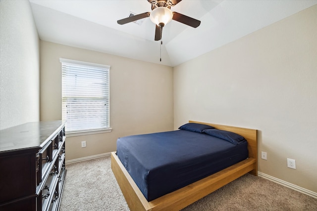 bedroom with light carpet, vaulted ceiling, and ceiling fan