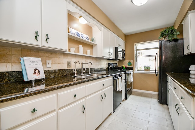 kitchen featuring sink, black appliances, light tile patterned floors, white cabinets, and tasteful backsplash