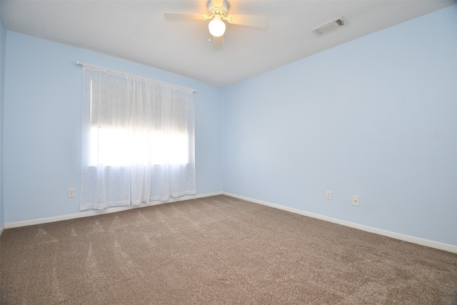 carpeted spare room featuring ceiling fan