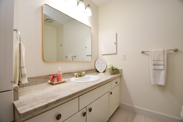 bathroom featuring vanity and hardwood / wood-style flooring