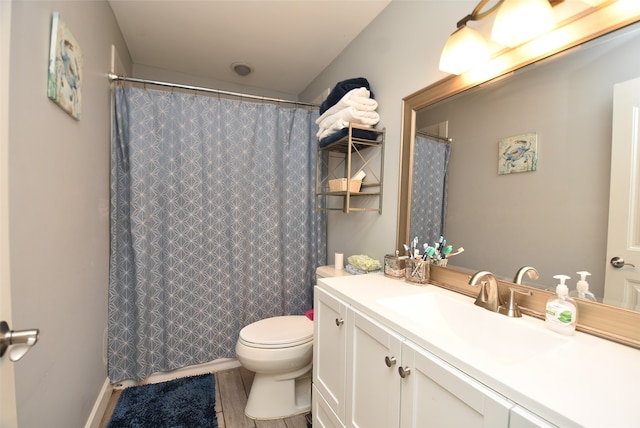 bathroom with vanity, hardwood / wood-style floors, curtained shower, and toilet