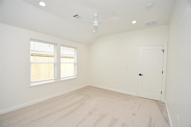 carpeted empty room with ceiling fan and vaulted ceiling