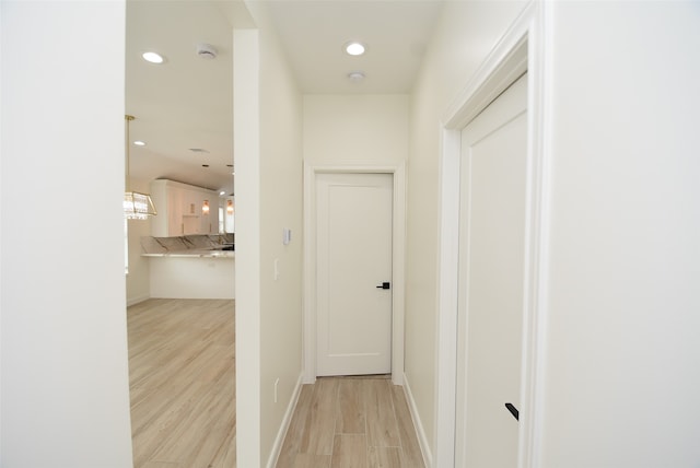 corridor with light hardwood / wood-style flooring