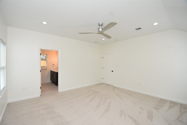 carpeted empty room featuring ceiling fan and lofted ceiling