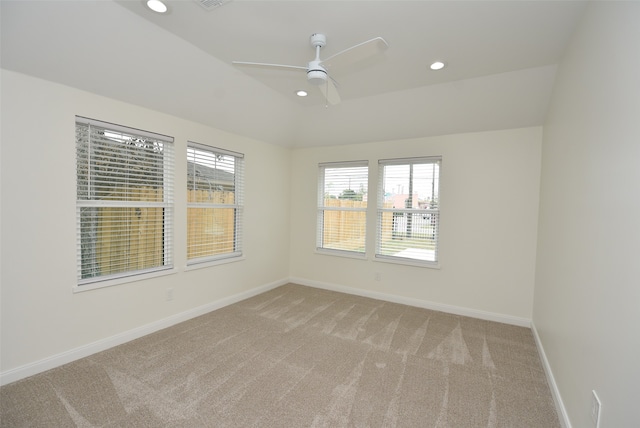 carpeted spare room featuring ceiling fan and a healthy amount of sunlight