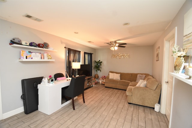 living room featuring ceiling fan and light hardwood / wood-style flooring