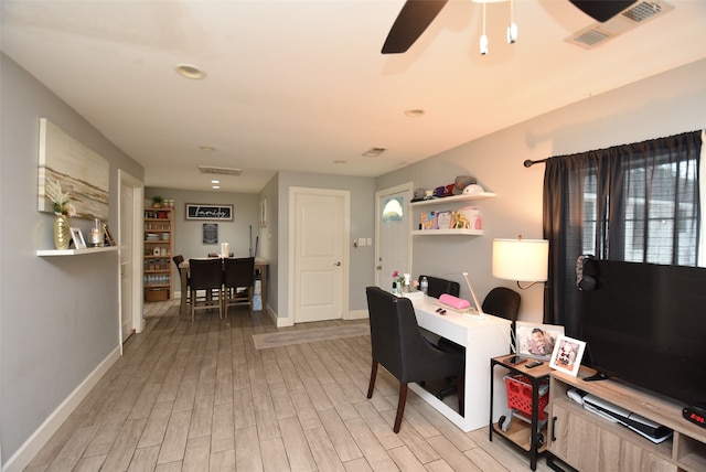 office with light hardwood / wood-style flooring and ceiling fan