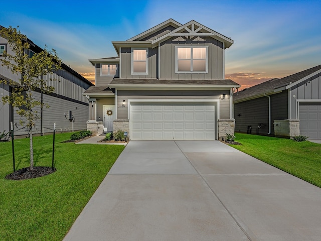 craftsman house with a lawn and a garage