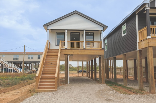 view of front facade with covered porch and a carport