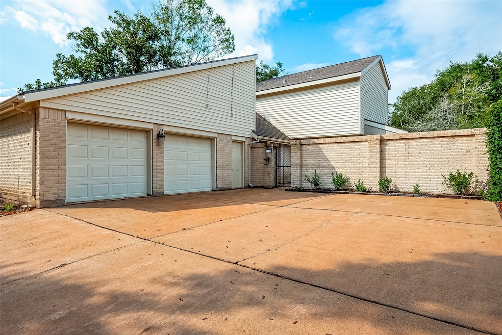 rear view of house featuring a garage