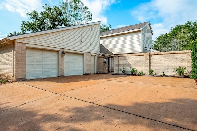 rear view of house featuring a garage