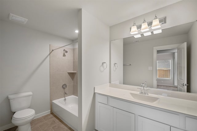 full bathroom with vanity, tiled shower / bath combo, toilet, and tile patterned flooring