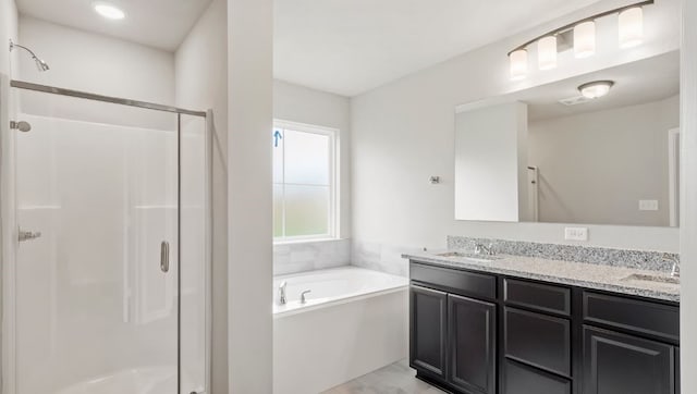 bathroom with vanity and plus walk in shower