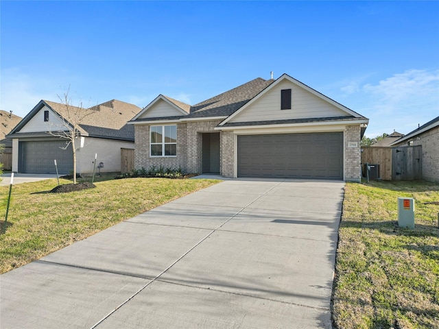 ranch-style home with concrete driveway, an attached garage, brick siding, and a front yard