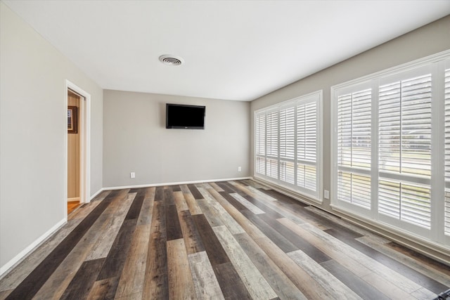 spare room featuring dark hardwood / wood-style floors