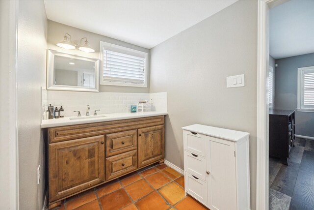 bathroom with backsplash, vanity, and hardwood / wood-style floors