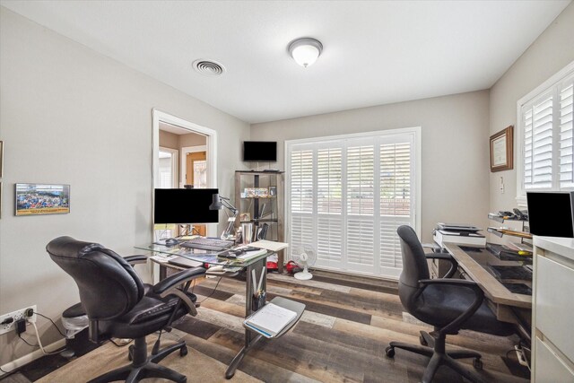 home office with wood-type flooring