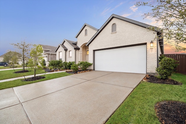 view of front facade with a yard and a garage