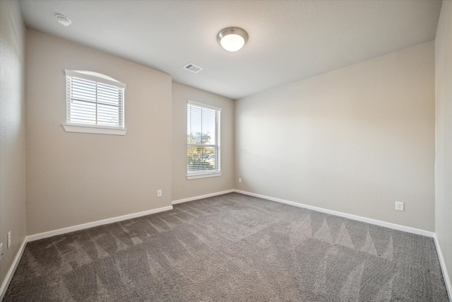 empty room with dark carpet