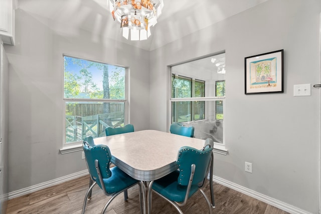 dining room with hardwood / wood-style floors and a notable chandelier