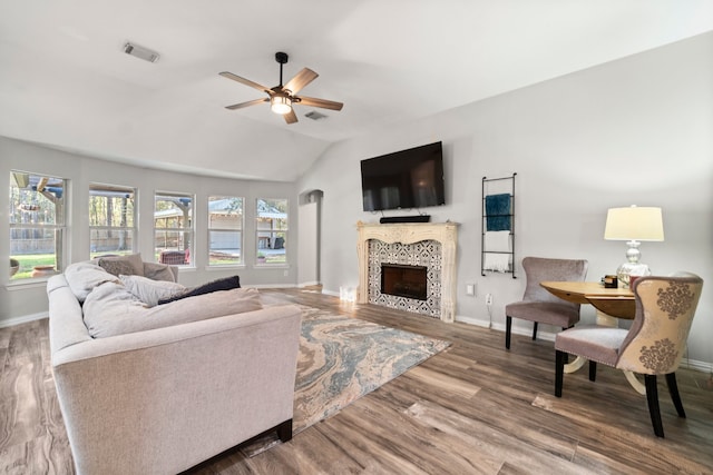 living room featuring a fireplace, wood-type flooring, ceiling fan, and lofted ceiling