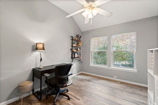 office space featuring light hardwood / wood-style flooring, lofted ceiling, and ceiling fan