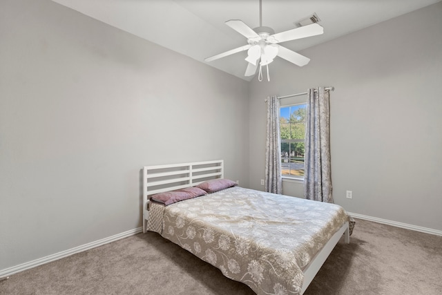 bedroom featuring ceiling fan, carpet flooring, and lofted ceiling