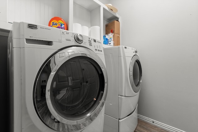 washroom with washer and dryer and dark hardwood / wood-style floors