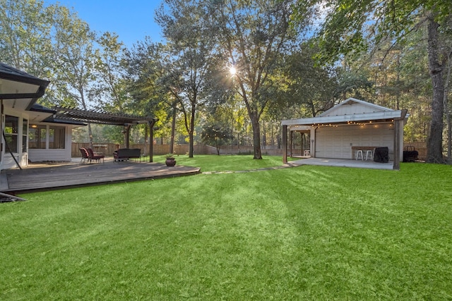 view of yard featuring a wooden deck and a pergola