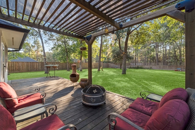 wooden deck with a lawn, an outdoor living space with a fire pit, and a pergola