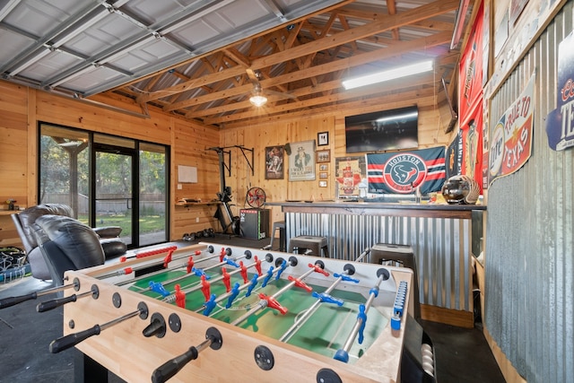 recreation room with wooden walls