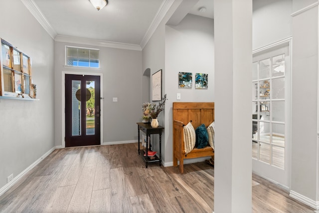 foyer entrance with hardwood / wood-style floors and crown molding