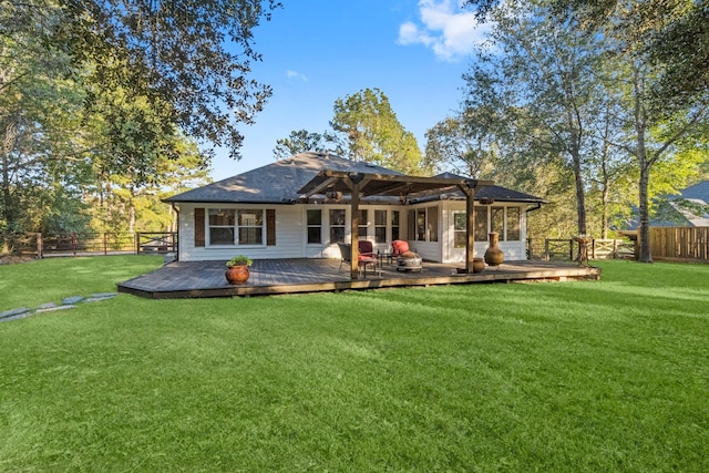 rear view of house featuring a yard and a wooden deck