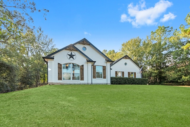 rear view of house featuring a lawn