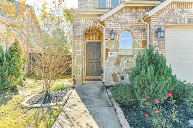 doorway to property with a garage