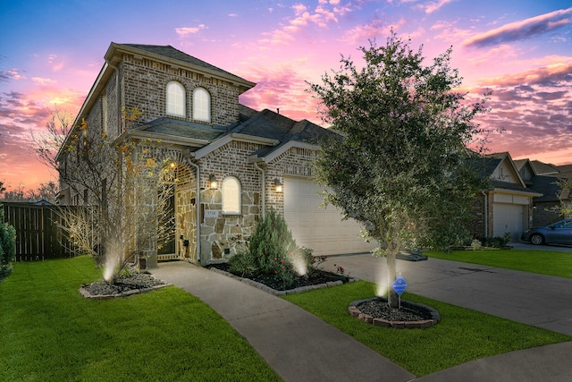 view of front of home with a yard and a garage