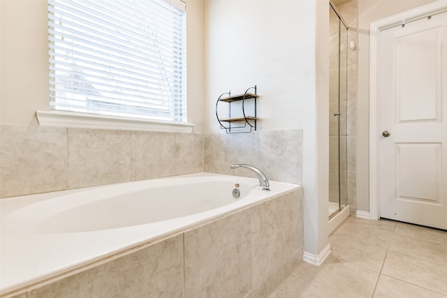 bathroom featuring tile patterned floors and shower with separate bathtub