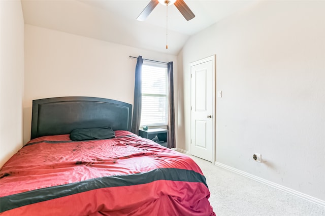 carpeted bedroom with vaulted ceiling and ceiling fan