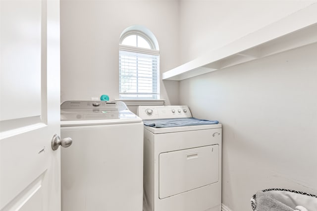 washroom with washing machine and clothes dryer