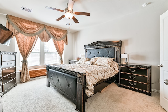 bedroom featuring light colored carpet and ceiling fan