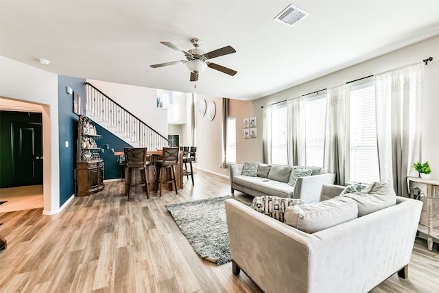 living room featuring light hardwood / wood-style floors and ceiling fan