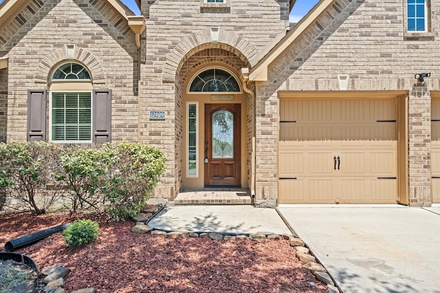 doorway to property with a garage