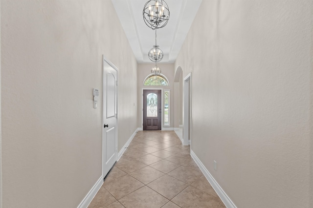 entryway featuring an inviting chandelier and light tile patterned floors