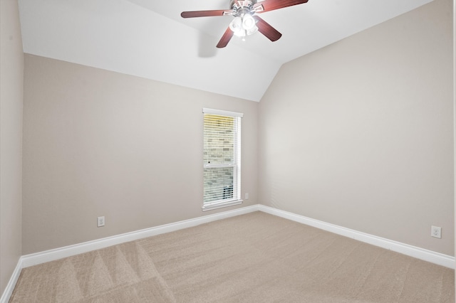 unfurnished room featuring light carpet, vaulted ceiling, and ceiling fan