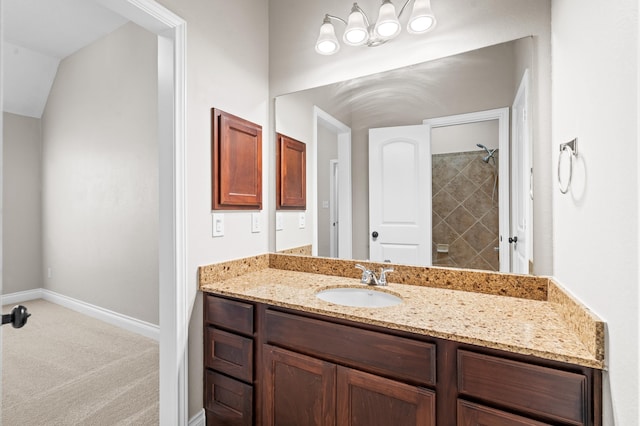 bathroom with vanity and a tile shower