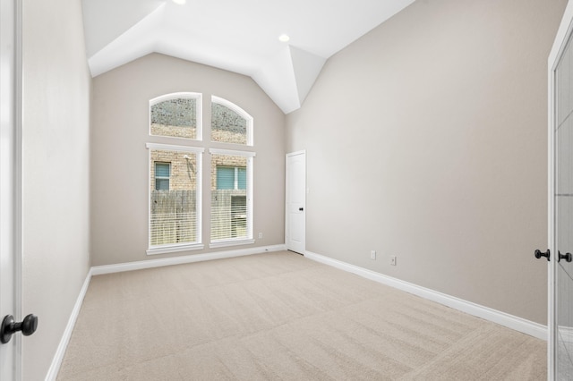 unfurnished room featuring light carpet, a healthy amount of sunlight, and lofted ceiling