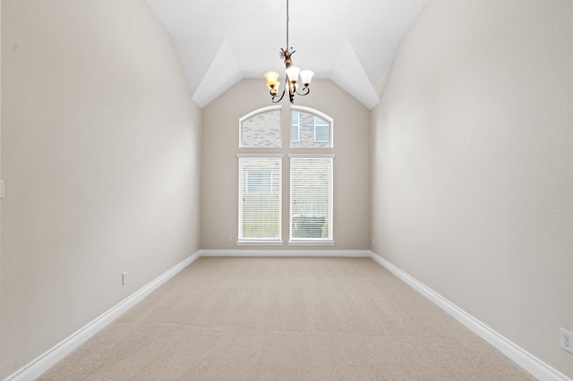 unfurnished room featuring light colored carpet, lofted ceiling, and an inviting chandelier