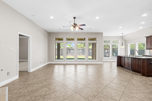 unfurnished living room with ceiling fan and light tile patterned floors